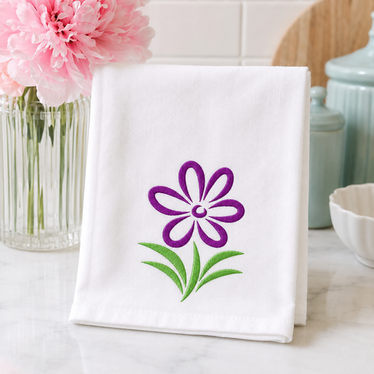 Beautiful Purple Flower embroidery design shown on a flour sack towel