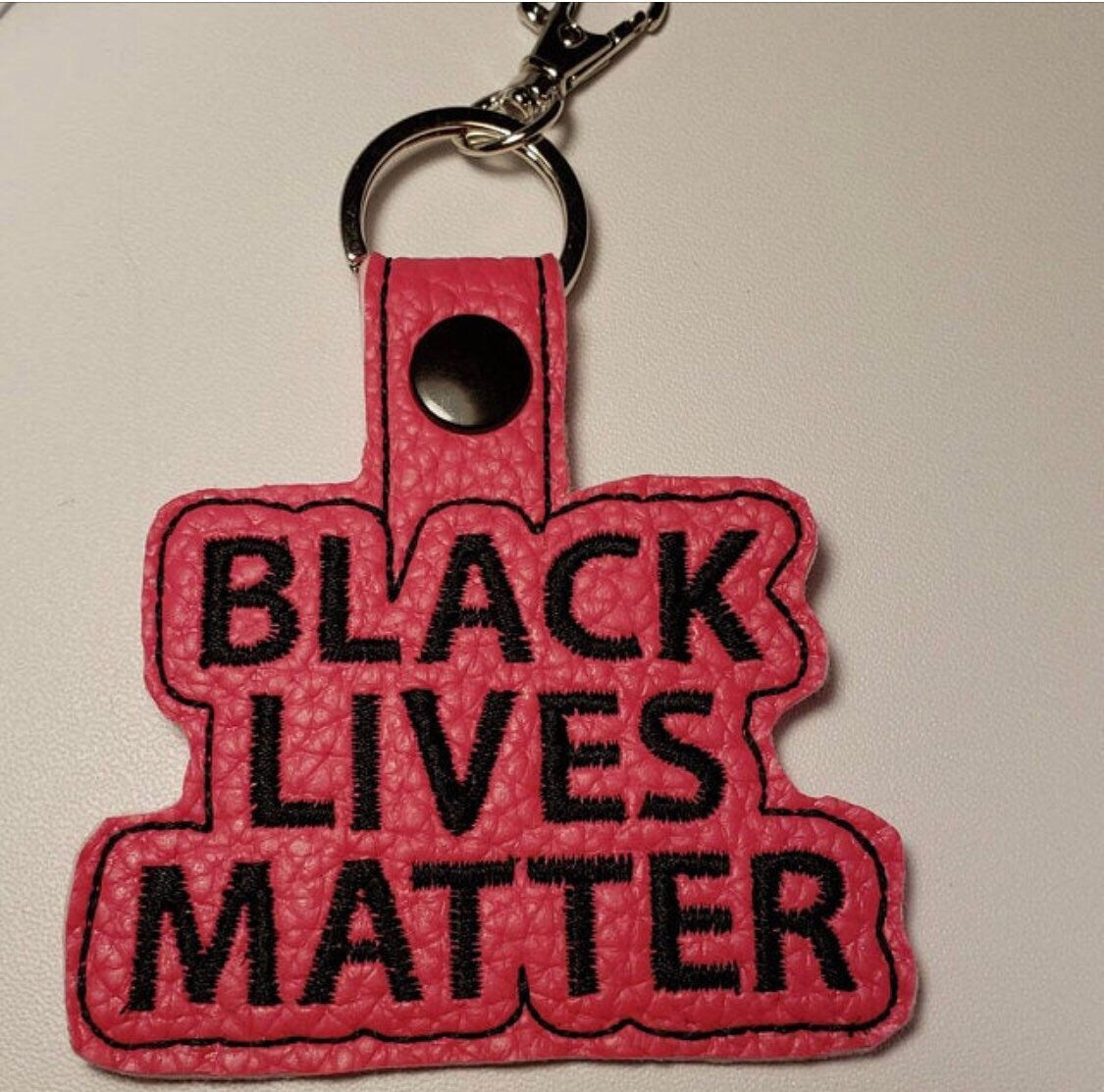In the Hoop Snap tab Black Lives Matter BOLD FONT Embroidery File- Comes with 4x4 and also 5x7 to make 2 snap tabs at one time.